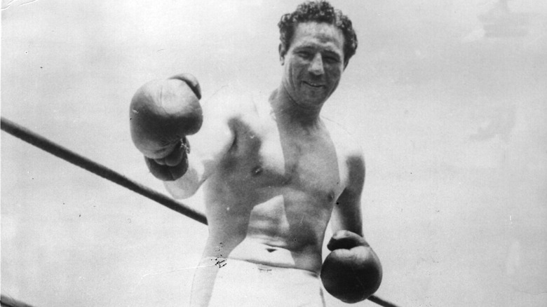 Max Baer poses outside a boxing ring