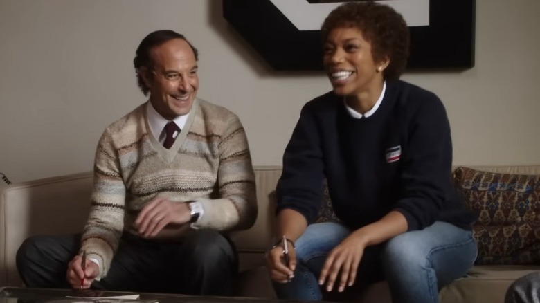 Whitney Houston and Clive Davis sitting together