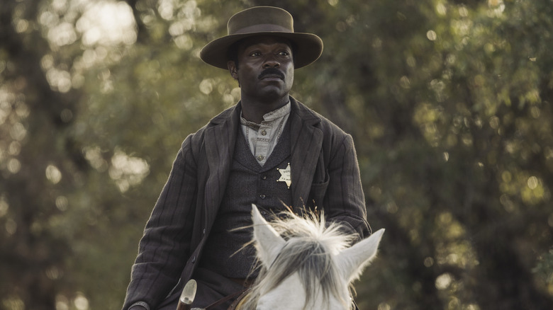 Bass Reeves in front of horse