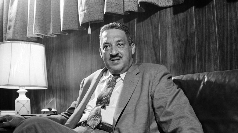 Thurgood Marshall seated on couch