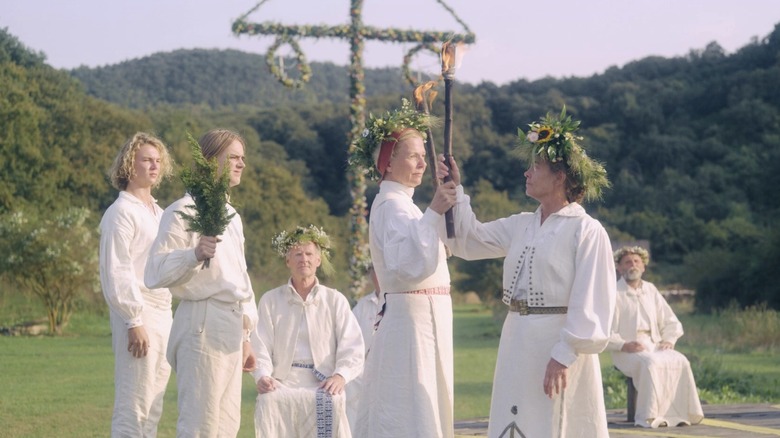 Women touch torches together