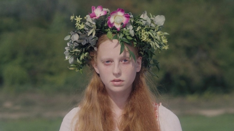 Maya looks at camera in flower crown