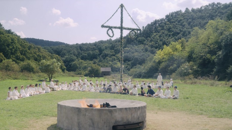 Group sits under maypole