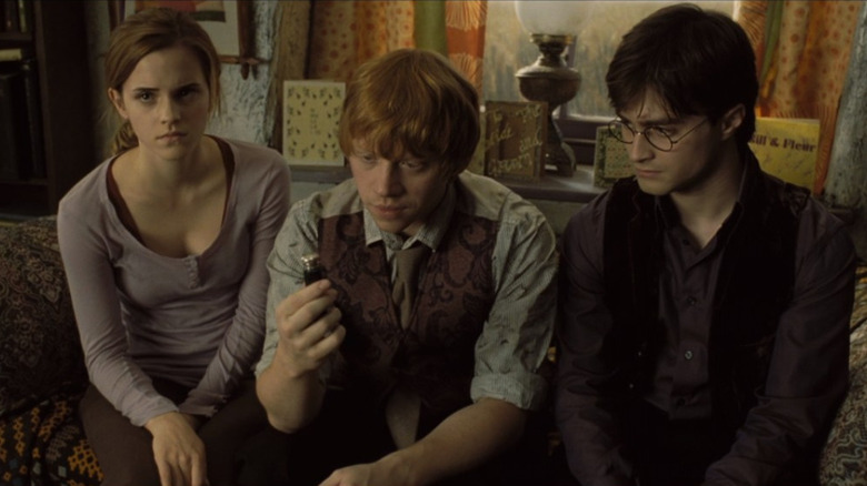 Hermione Granger, Ron Weasley, and Harry Potter sitting