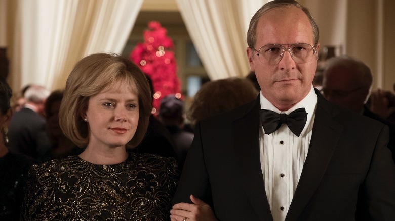 Christian Bale as Dick Cheney and Amy Adams as Lynne Cheney linking arms