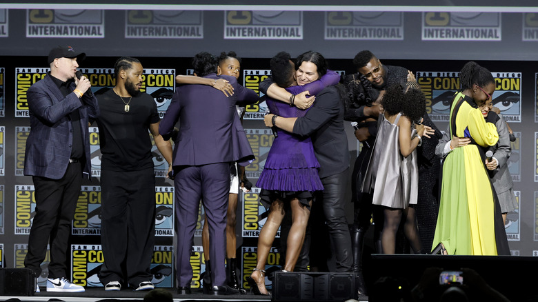 The cast of "Black Panther: Wakanda Forever" hugging at Comic-Con