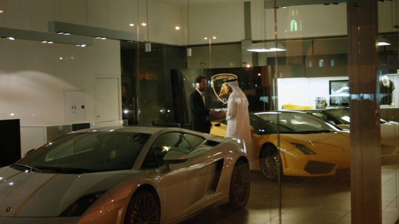 Men shake hands in Lamborghini dealership