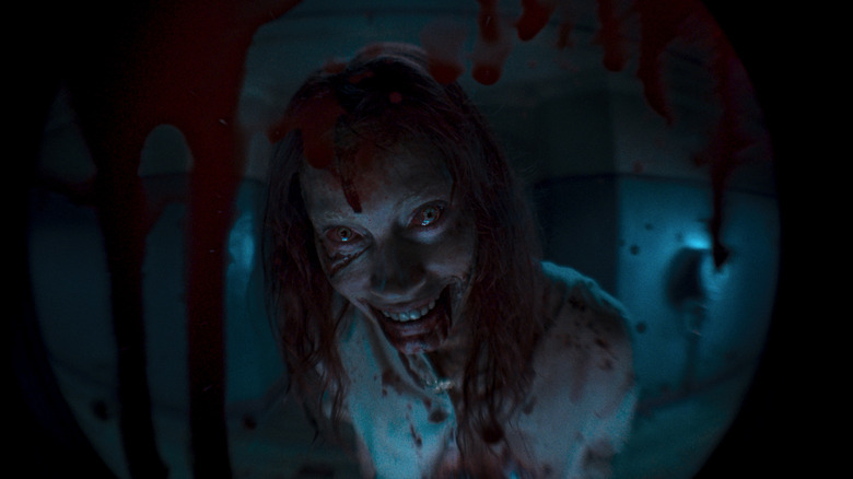 Alyssa Sutherland grinning covered in blood
