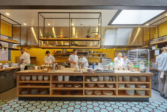 The bold, sunshine-yellow tile lining the kitchen speaks to Chef Ravi Kapur's Hawaiian roots. (Photo credit: Studio Terpeluk) 