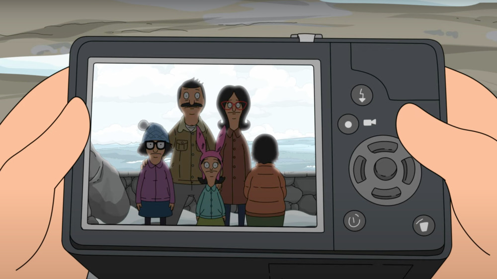 Linda Belcher holding camera with family photo Bob's Burgers