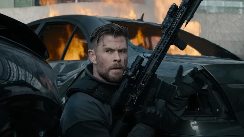 Chris Hemsworth loads rifle