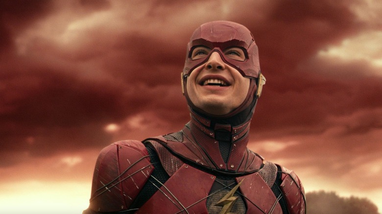 The Flash grins with clouds behind him