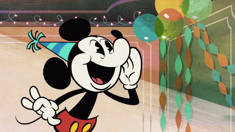 Mickey smiling wearing a birthday hat