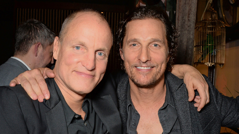 Matthew McConaughey and Woody Harrelson hugging, smiling