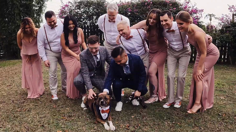 Family petting a dog during a wedding