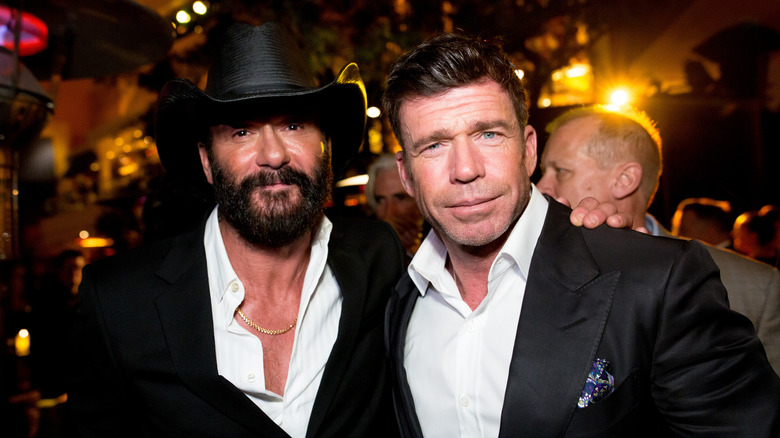 Tim McGraw and Taylor Sheridan posing together at the 1883 premiere afterparty