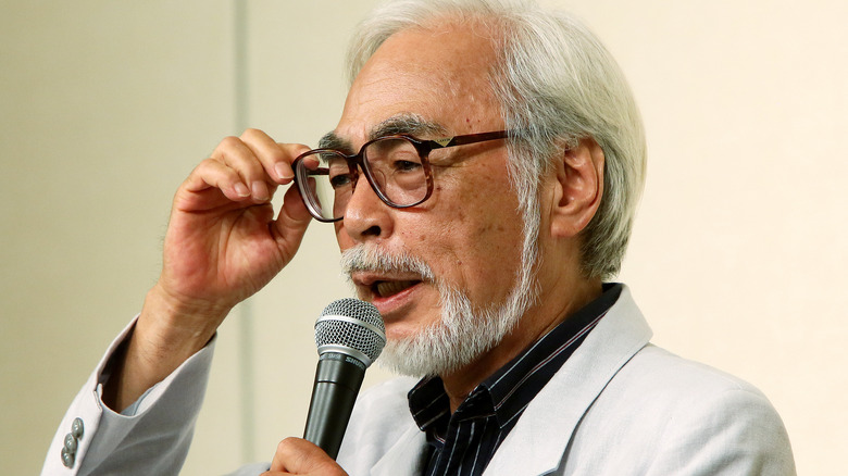 Miyazaki holding microphone