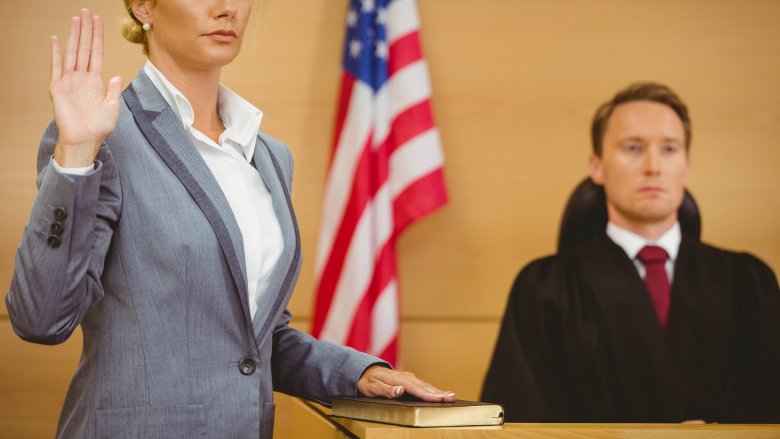 Woman being sworn in on a bible