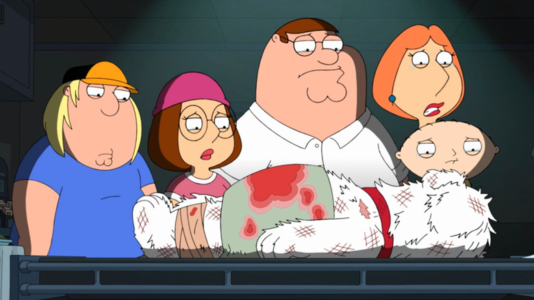 Griffin family looking over Brian's body