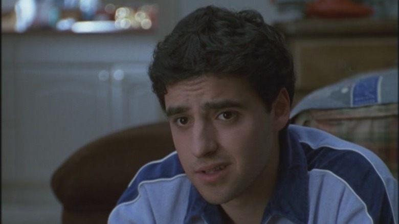 David Krumholtz sitting by a bed