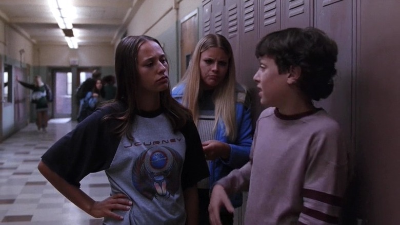 Rashida Jones standing by lockers