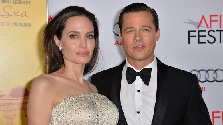 Brad Pitt and Angelina Jolie stand together