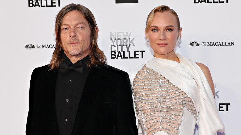 Norman Reedus and Diane Kruger stand together