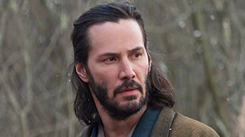 Keanu Reeves stares into forest