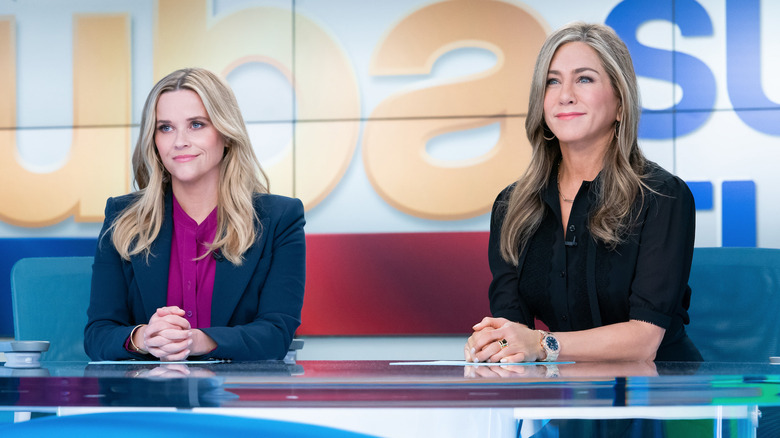 Reese Witherspoon and Jennifer Aniston at the news desk on The Morning Show