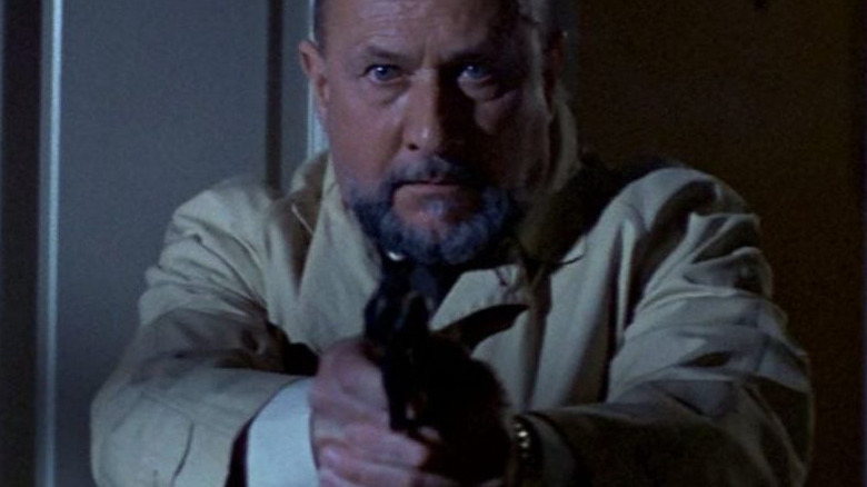 Dr. Sam Loomis points gun