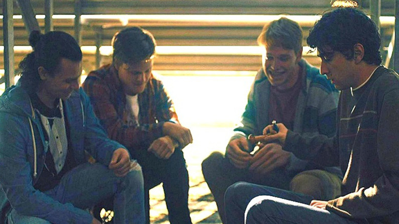 Peter and his friends sit under bleachers