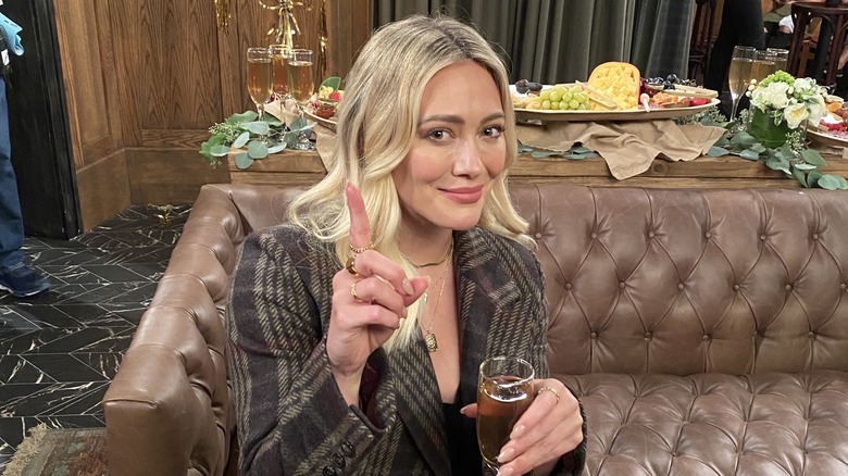 Hilary Duff as Sophie with glass of champagne on How I Met Your Father