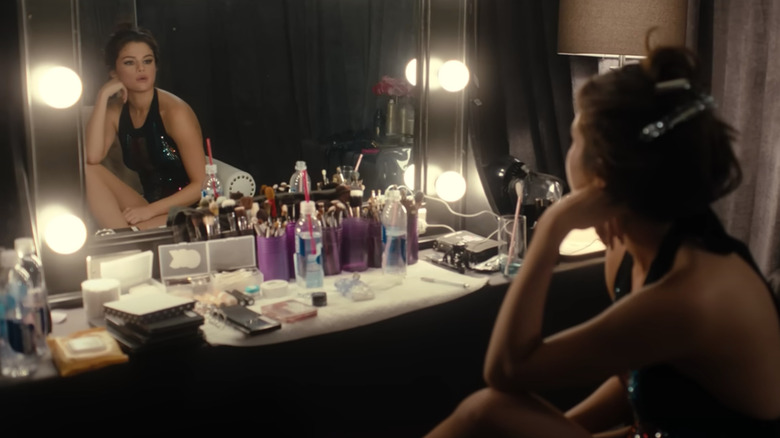 Selena Gomez looking at self in mirror