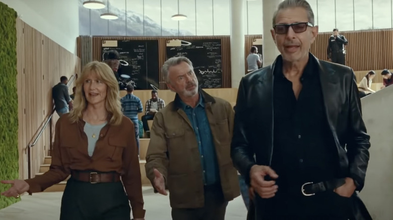 Laura Dern, Sam Neil, and Jeff Golblum walking and talking 