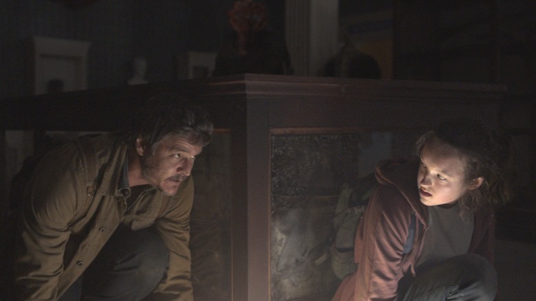 Pedro Pascal and Bella Ramsey hiding from the infected