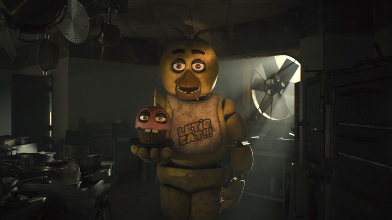 Chica holds a cupcake animatronic