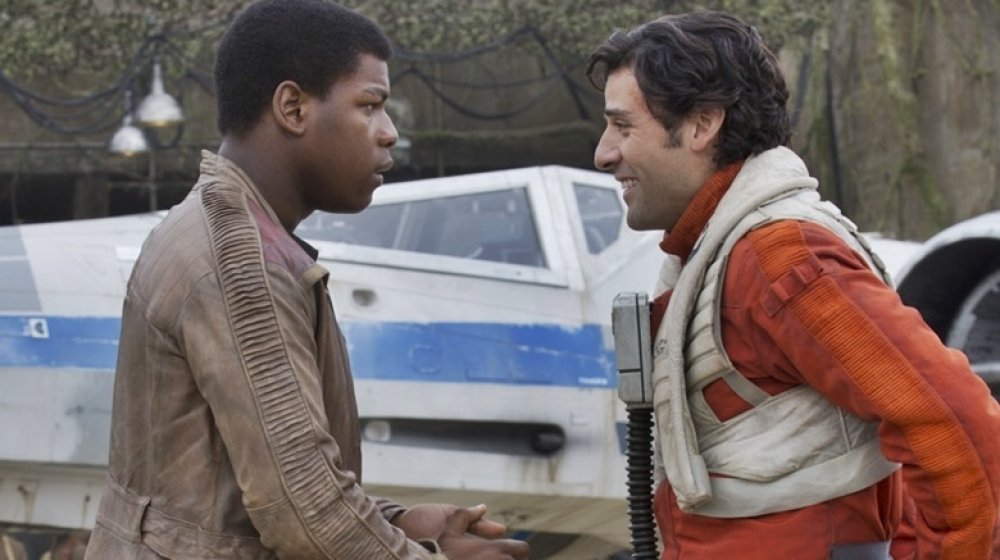 John Boyega and Oscar Isaac as Finn and Poe Dameron