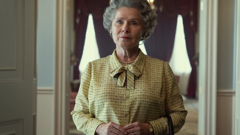 Imelda Staunton as Queen Elizabeth II standing