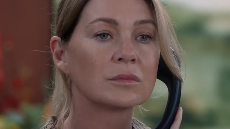 Dr. Meredith Grey holding phone up to ear