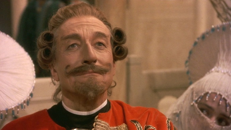 Baron Munchausen smiling with women