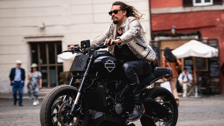 Jason Momoa rides a motorcycle