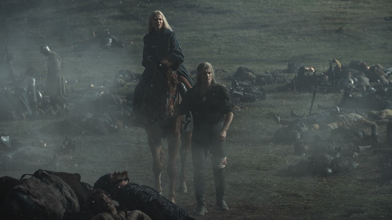 Ciri on horse next to Geralt