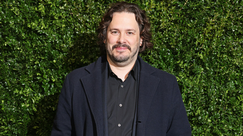 Edgar Wright in front of hedge wall