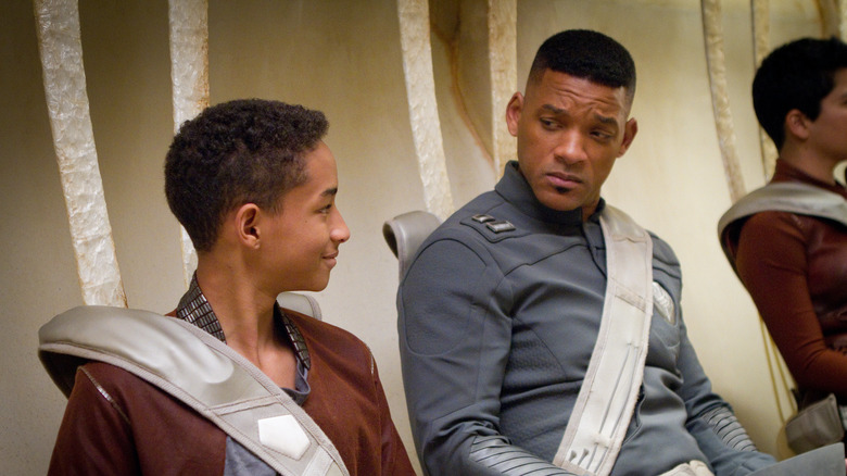 Jaden and Will Smith strapped into ship