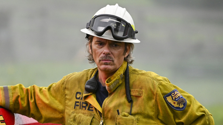 Vince Leone stands beside a firetruck in 