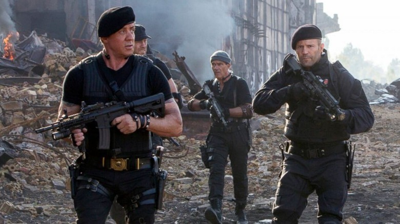 The Expendables walking through rubble