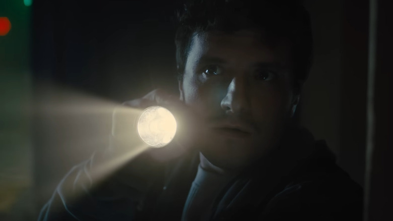 Josh Hutcherson holds flashlight