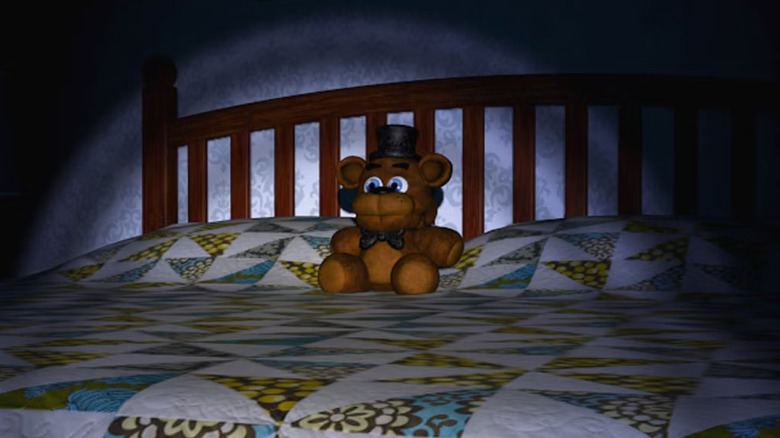 Freddy plushie sitting on bed