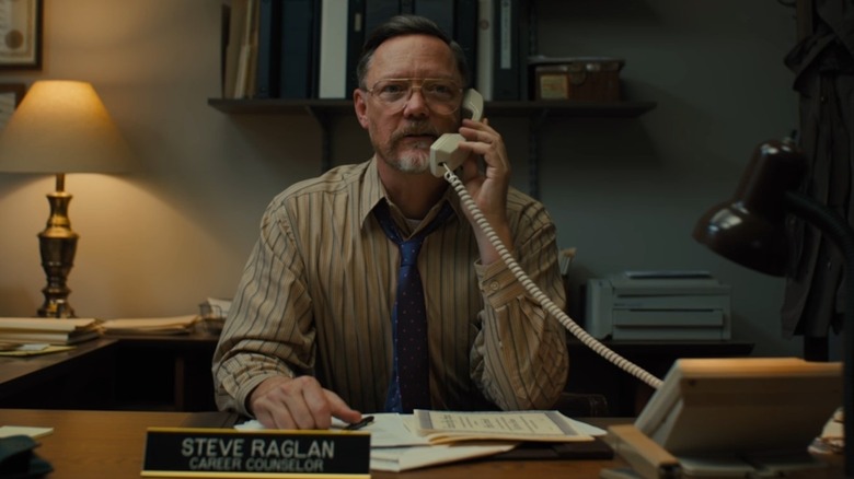 Steve Raglan at desk using phone