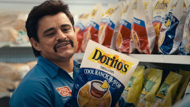 Jesse Garcia as Richard Montañez holding a bag of Doritos